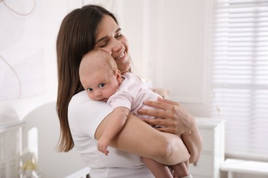 Young woman with her little baby at home