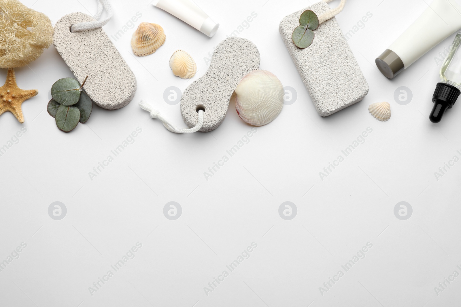 Photo of Flat lay composition with pumice stones on light background. Space for text