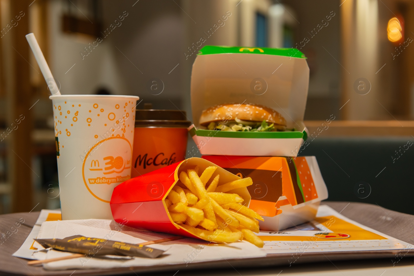 Photo of WARSAW, POLAND - SEPTEMBER 04, 2022: McDonald's French fries, burgers and drinks on table indoors