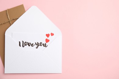 Photo of Love letter and envelope on pink background, flat lay. Space for text