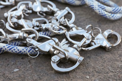 Climbing rope with carabiners on asphalt, closeup