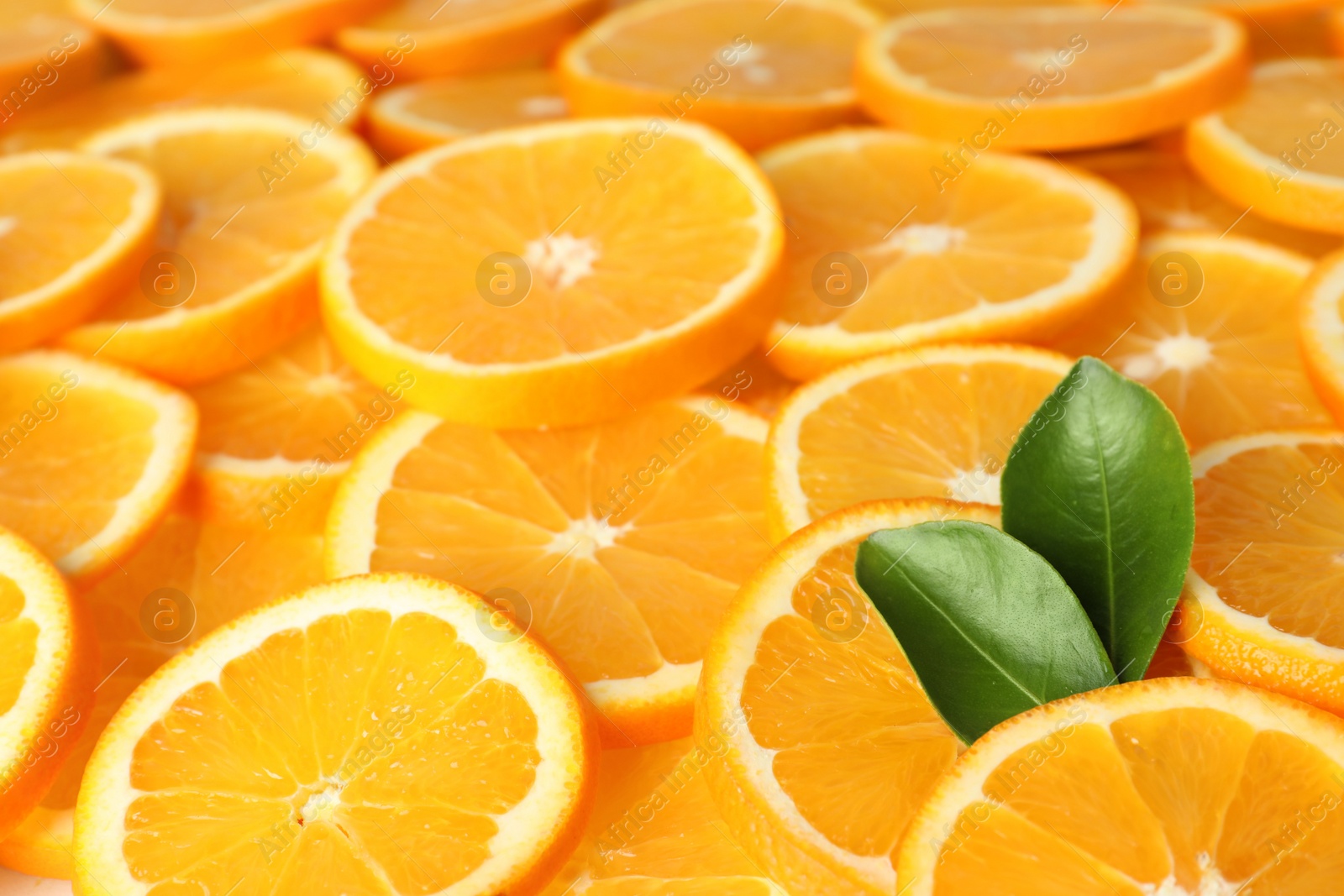 Photo of Many sliced fresh ripe oranges as background, closeup