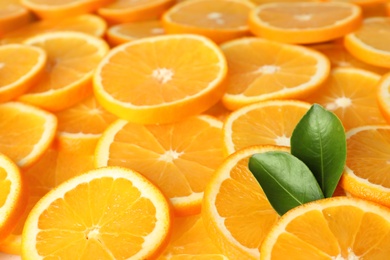 Photo of Many sliced fresh ripe oranges as background, closeup