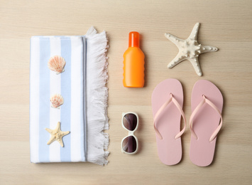 Photo of Flat lay composition with beach objects on wooden background