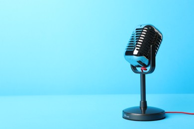 Photo of Retro microphone on light blue background, space for text. Interview