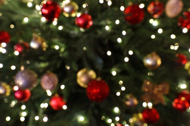 Blurred view of beautifully decorated Christmas tree, closeup