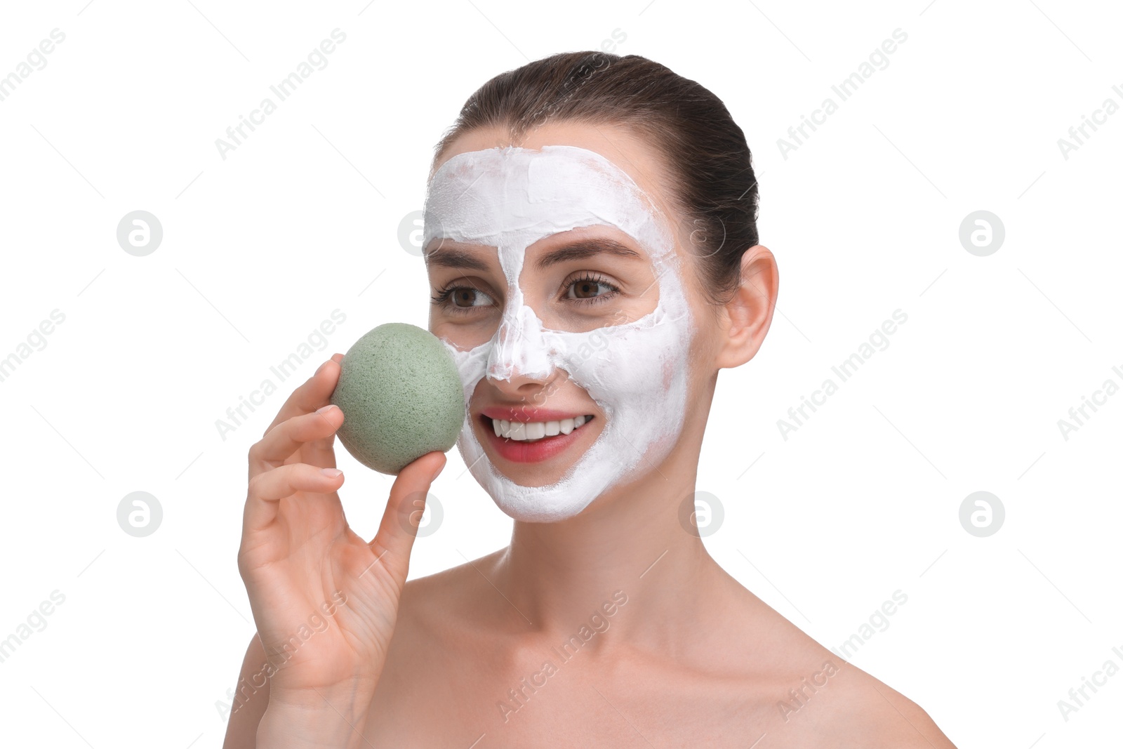 Photo of Happy young woman with face mask and sponge on white background