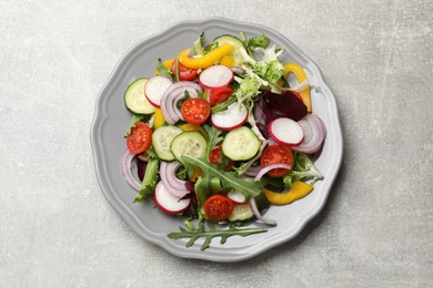 Photo of Balanced diet and vegetarian foods. Plate with different delicious products on grey table, top view