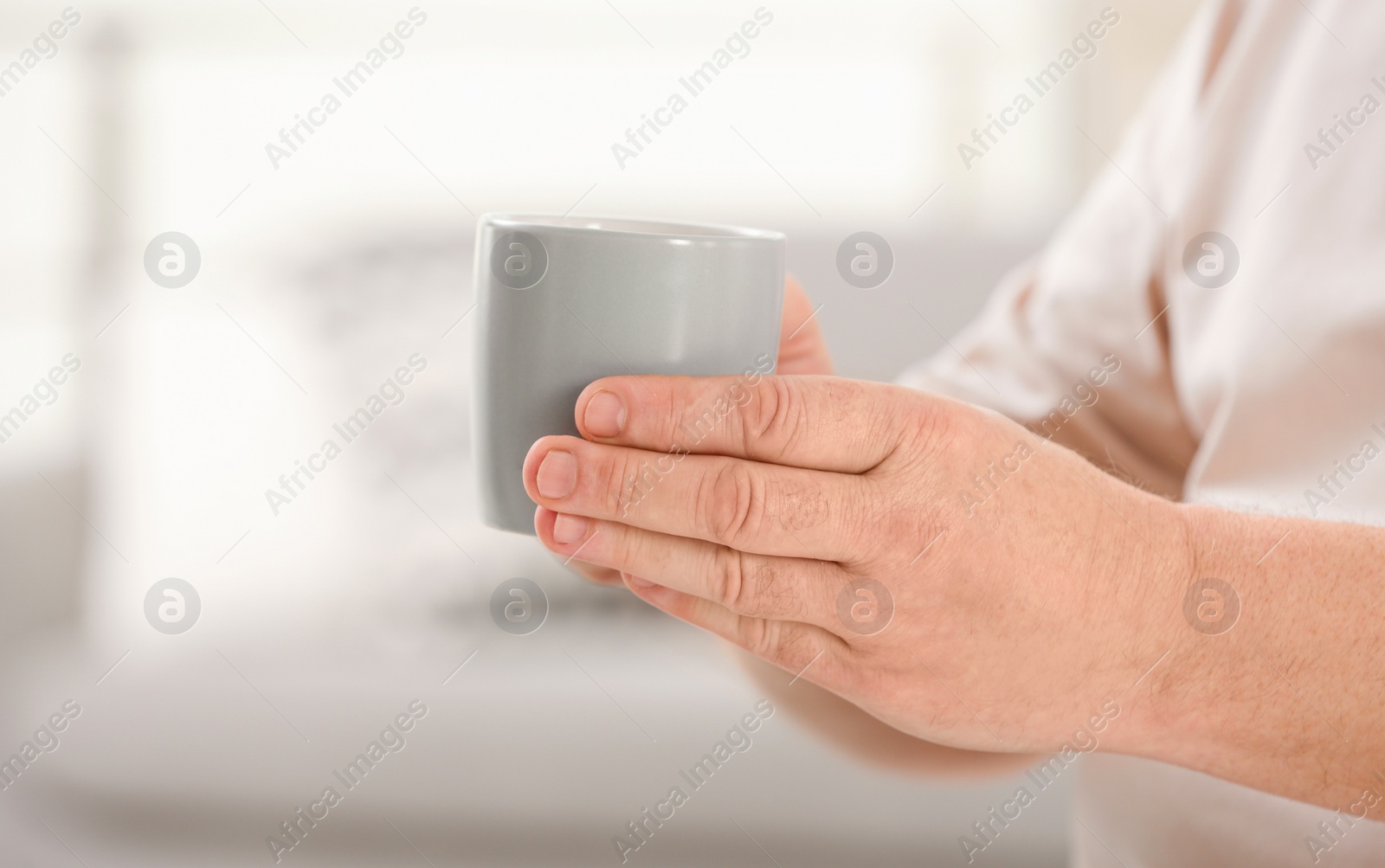 Photo of Closeup view of elderly man with cup of tea in nursing home, space for text. Assisting senior generation