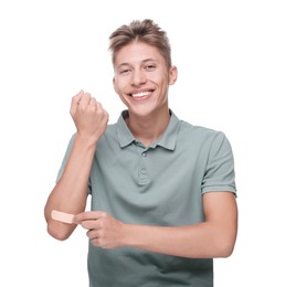 Handsome man putting sticking plaster onto elbow on white background