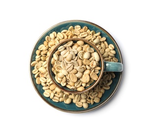 Photo of Cup and plate with green coffee beans on white background, top view