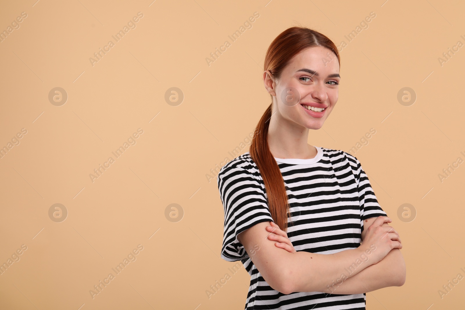 Photo of Beautiful woman with clean teeth smiling on beige background, space for text