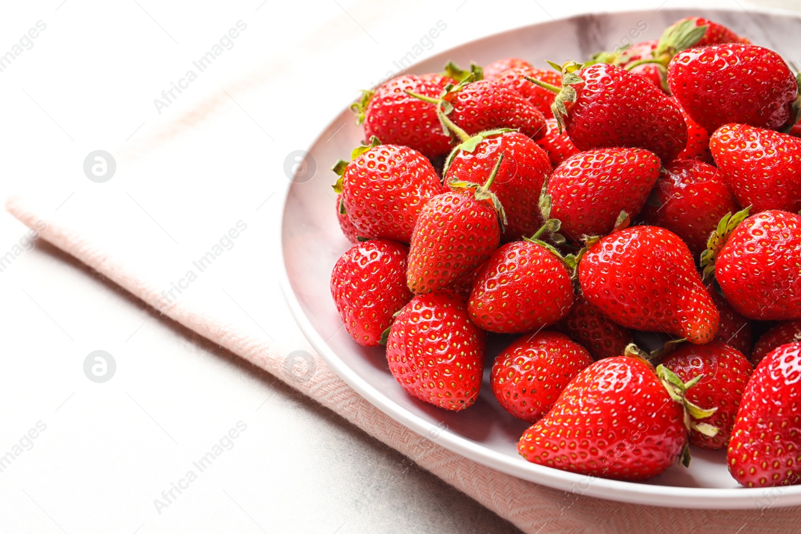 Photo of Plate with fresh ripe strawberries on table, closeup