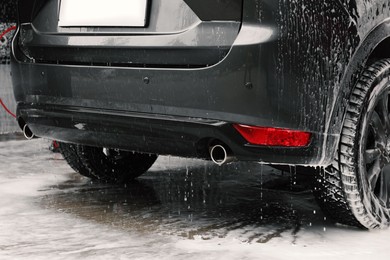 Black wet auto at car wash, closeup