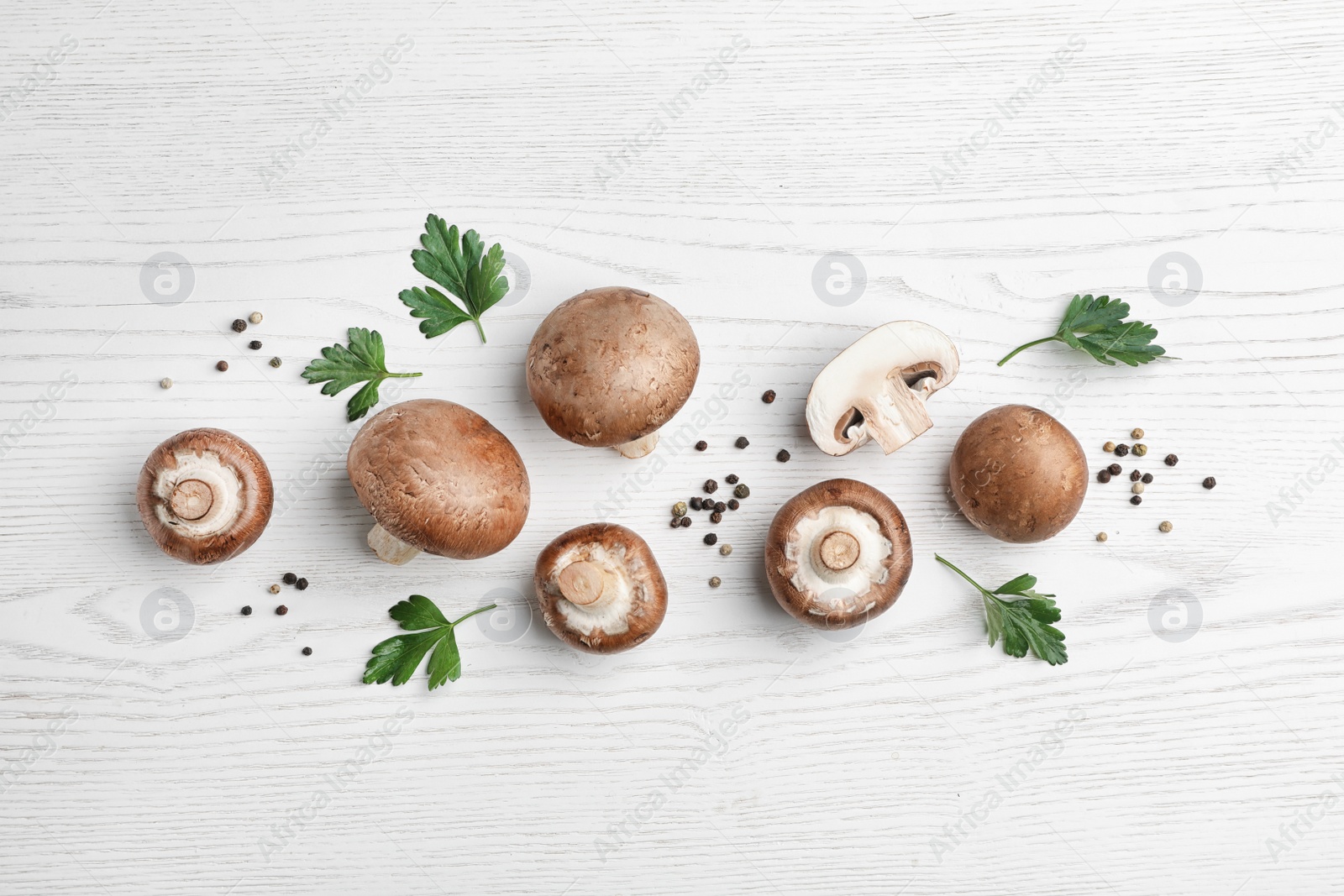 Photo of Flat lay composition with fresh champignon mushrooms on wooden table