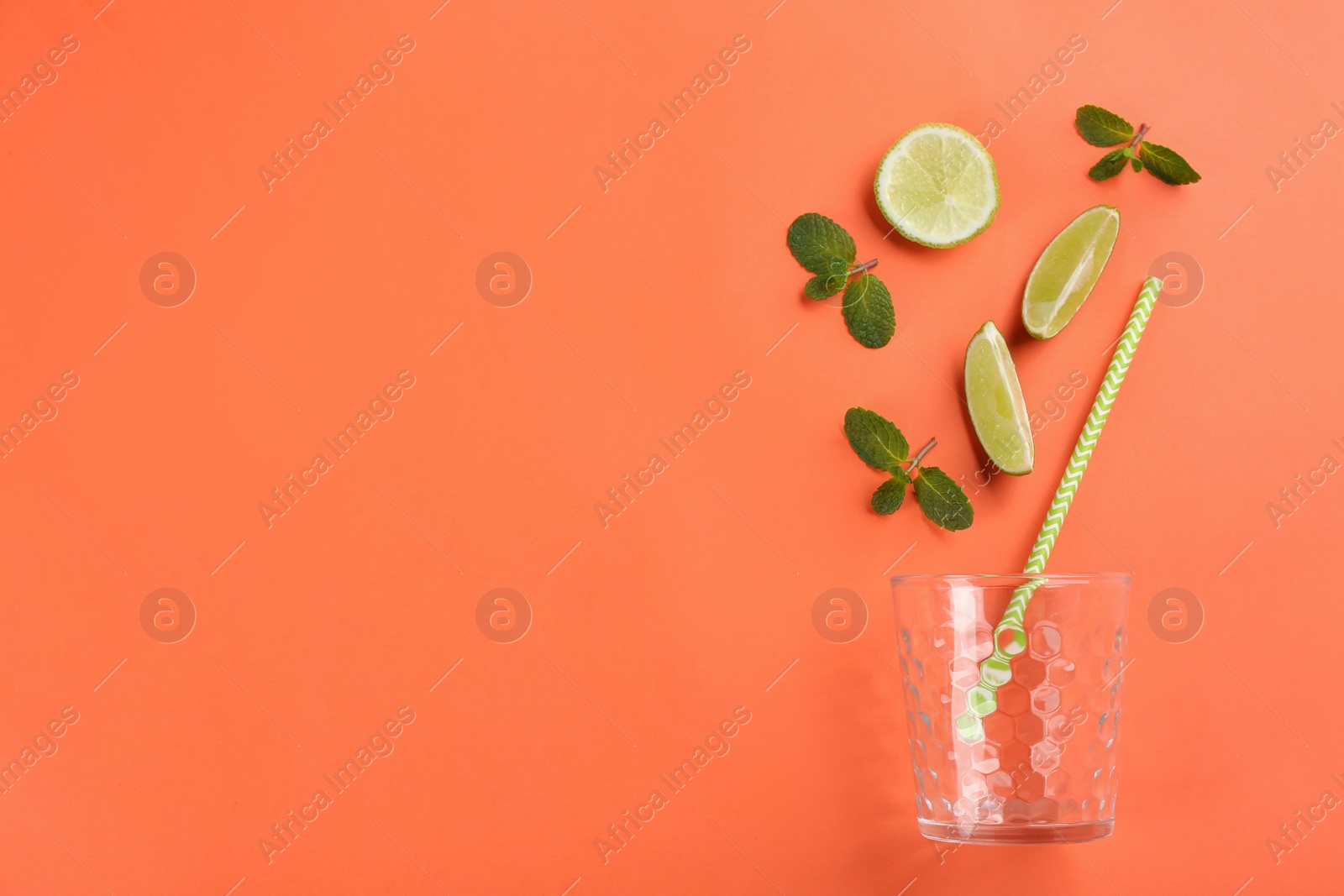 Photo of Creative lemonade layout with lime slices and mint on coral background, top view. Space for text