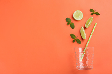 Photo of Creative lemonade layout with lime slices and mint on coral background, top view. Space for text