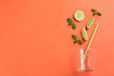 Creative lemonade layout with lime slices and mint on coral background, top view. Space for text