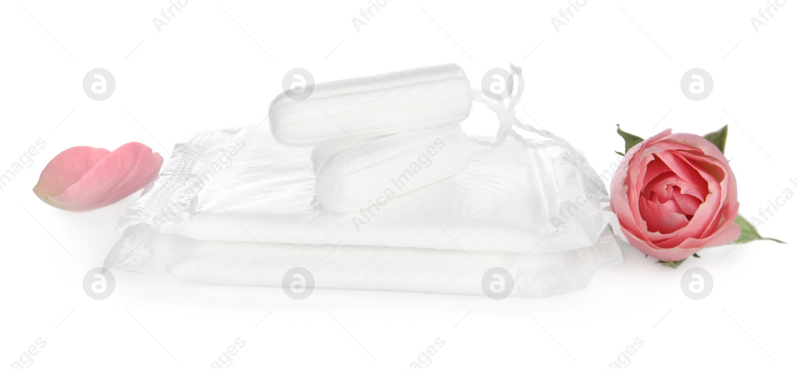 Photo of Tampons, disposable menstrual pads and beautiful rose on white background