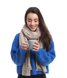 Young woman with cup of hot coffee on white background. Winter season