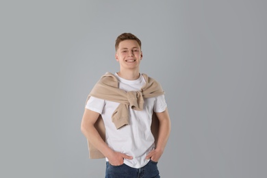 Photo of Portrait of teenage boy on light grey background