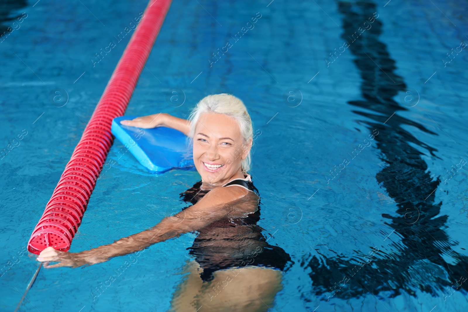 Photo of Sportive senior woman in indoor swimming pool