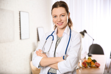 Photo of Professional nutritionist with stethoscope in her office