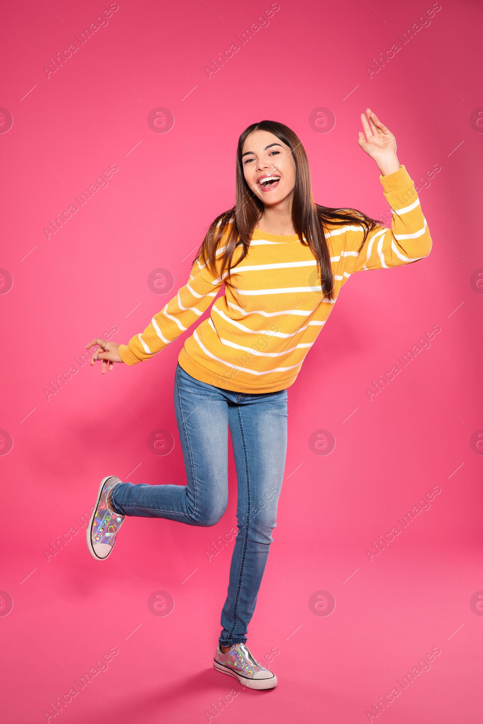 Photo of Full length portrait of emotional woman dancing on color background