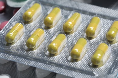 Yellow pills in blister, closeup. Medicinal treatment