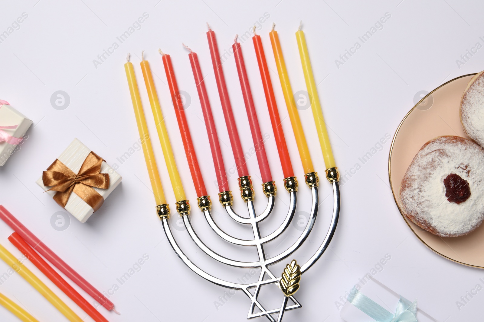 Photo of Flat lay composition with Hanukkah menorah and donuts on white background