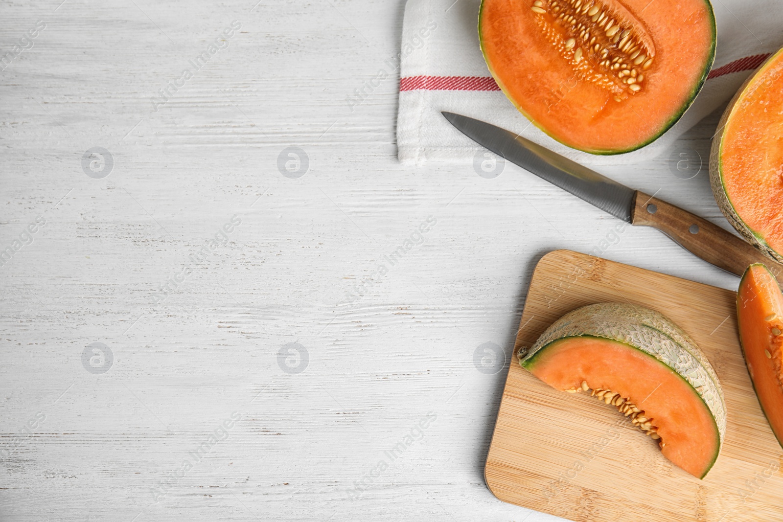 Photo of Composition with ripe cantaloupe melon and space for text on white wooden table