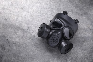 Photo of One gas mask on grey textured background, top view. Space for text