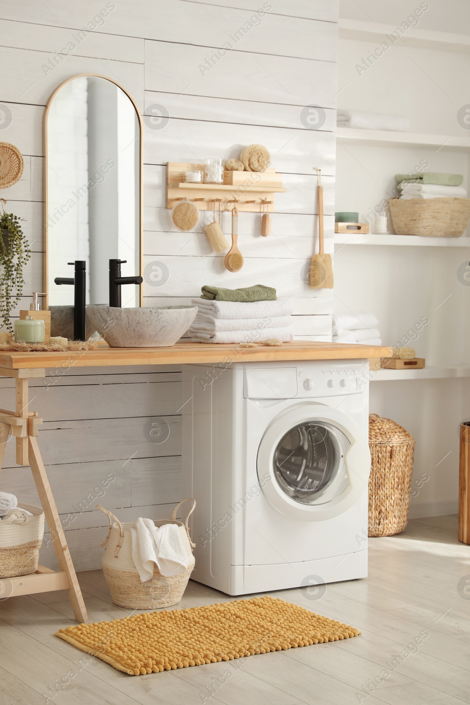 Photo of Stylish bathroom interior with modern washing machine