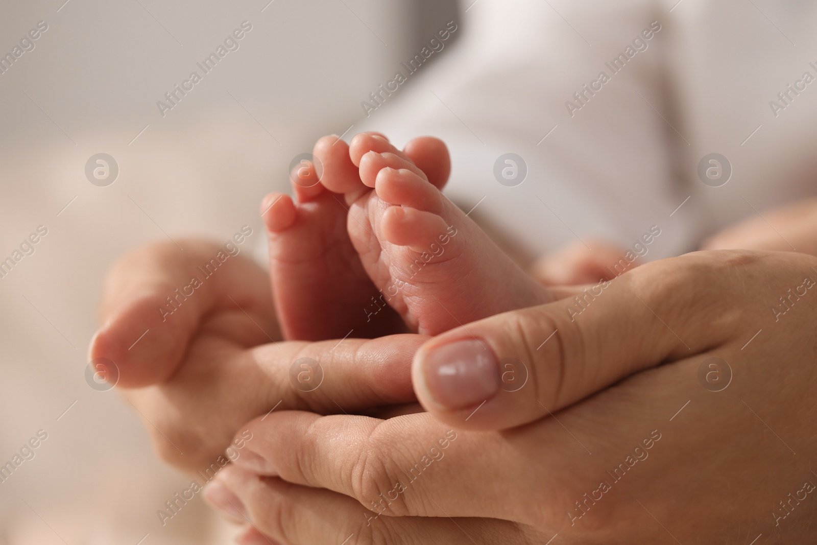 Photo of Mother holding her newborn baby, closeup view