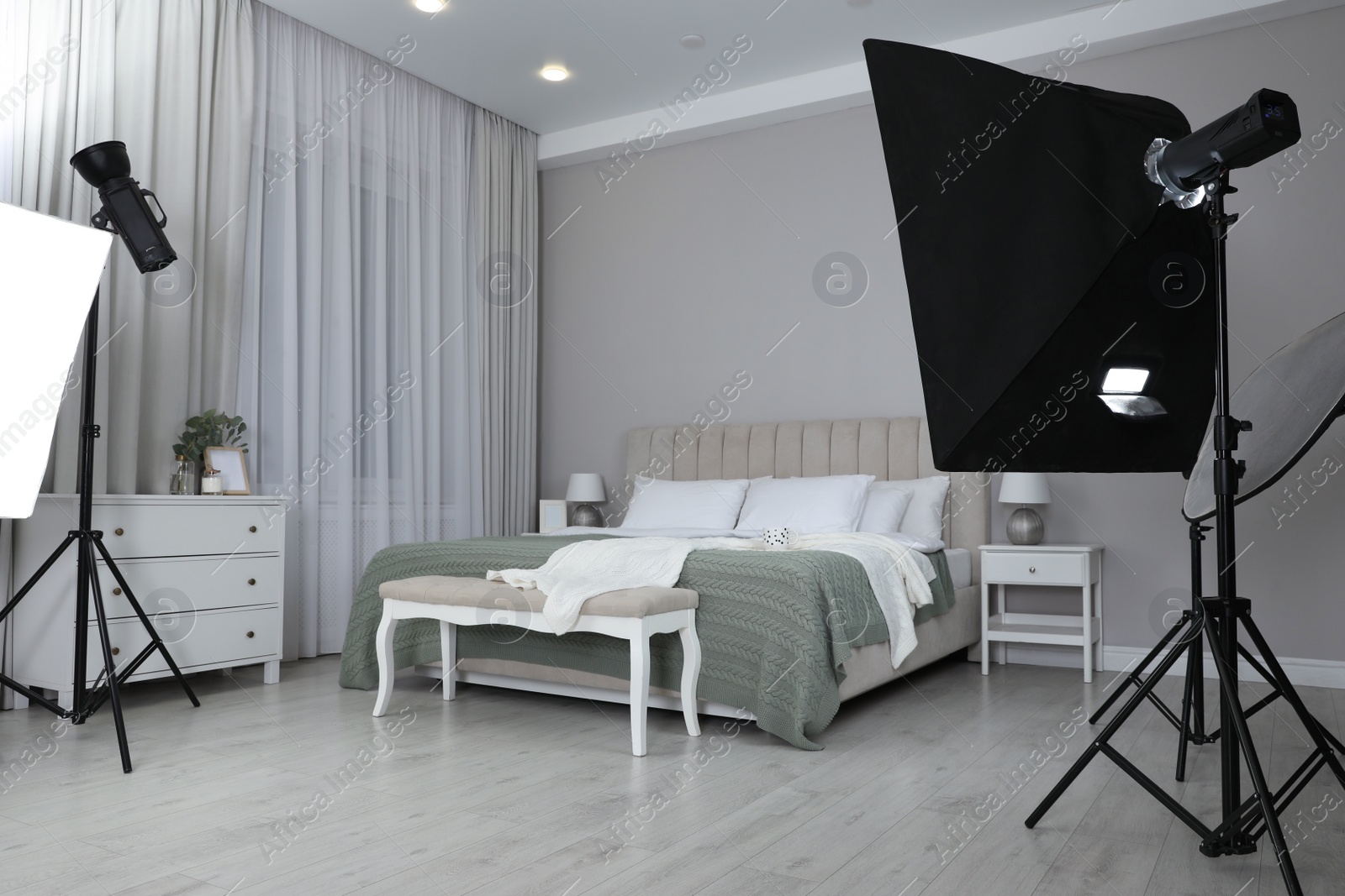 Photo of Professional photo studio equipment prepared for shooting bedroom interior