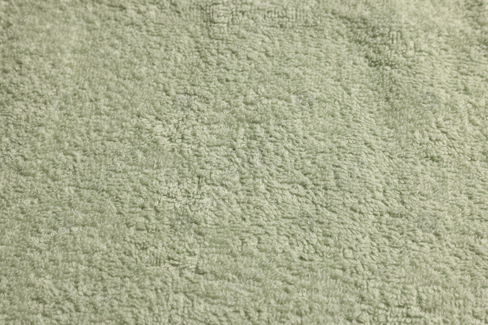 Photo of Soft pale olive towel as background, top view