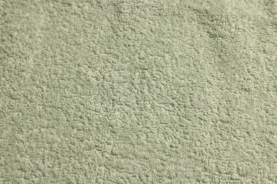 Soft pale olive towel as background, top view