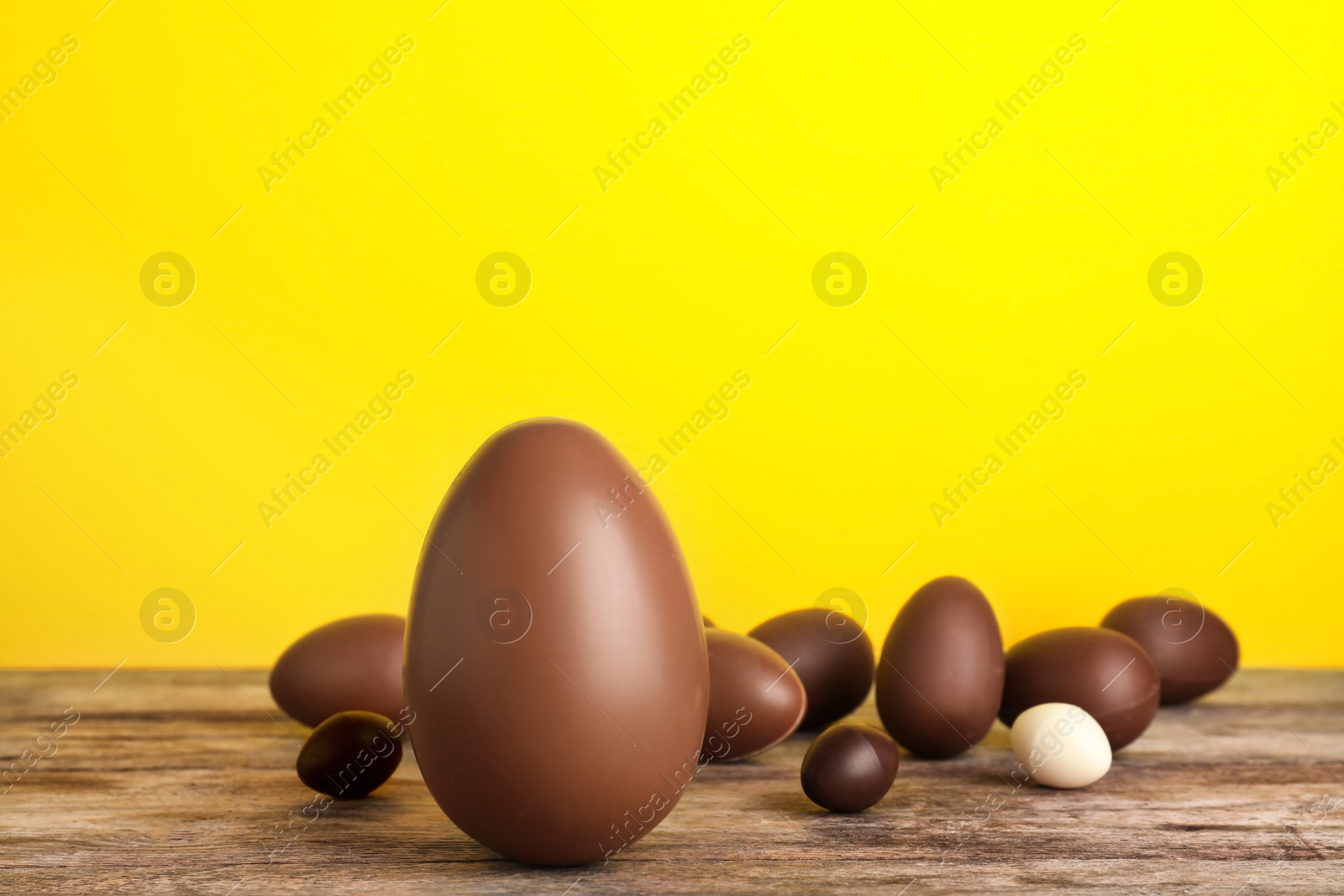 Photo of Beautiful composition with chocolate Easter eggs on wooden table