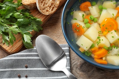 Bowl of fresh homemade vegetable soup served on table, top view