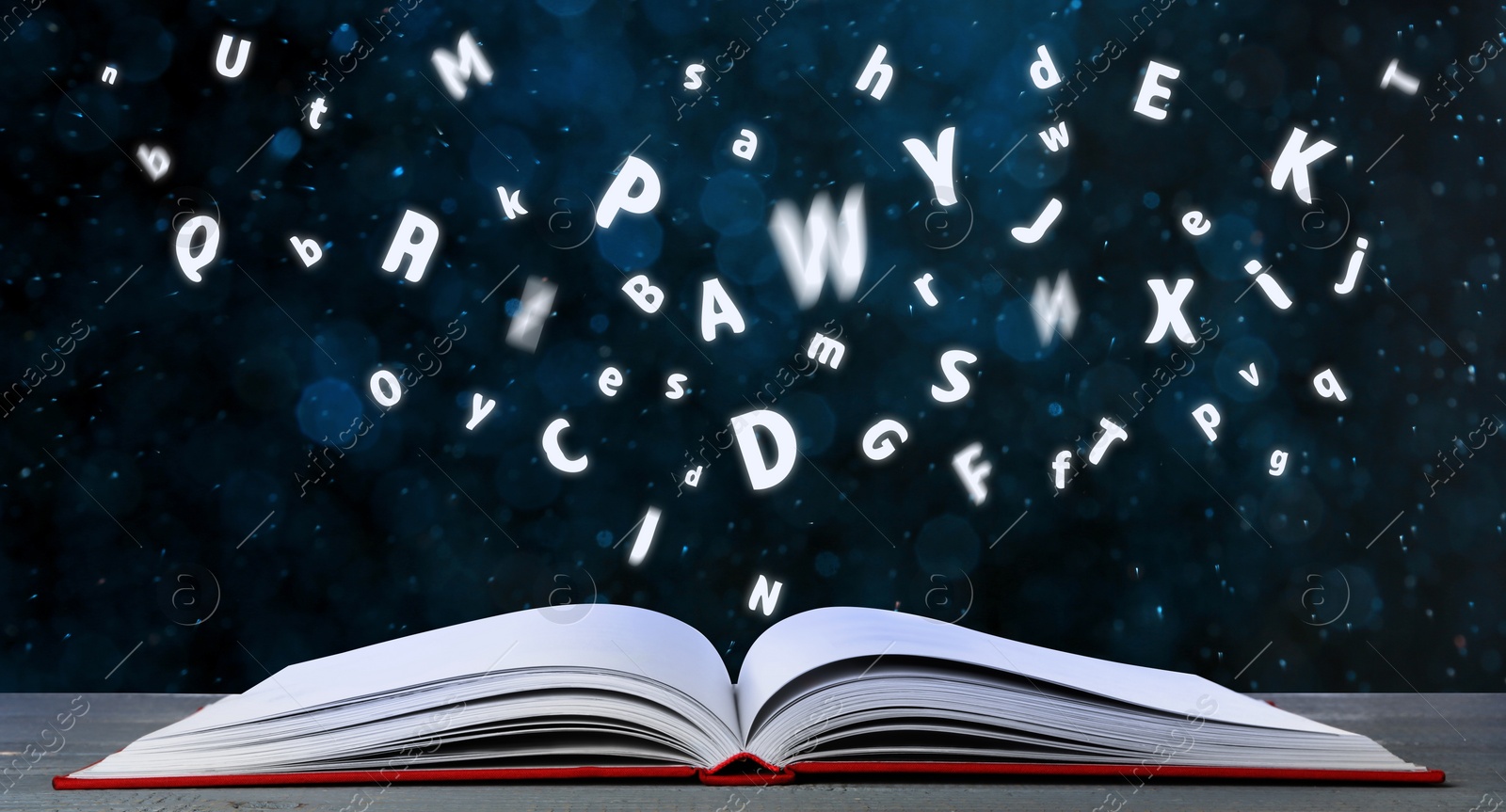 Image of Letters flying out of open book on table, bokeh effect. Banner design