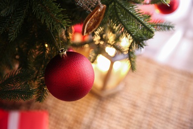 Photo of Beautiful Christmas tree decorated with festive lights and baubles indoors, closeup