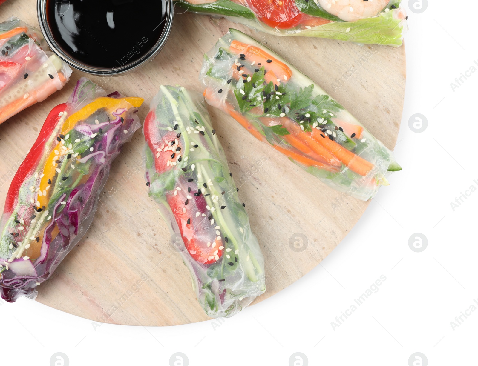 Photo of Serving board with delicious rolls wrapped in rice paper and teriyaki sauce on white background, top view