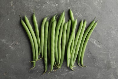Photo of Fresh green beans on grey table, flat lay