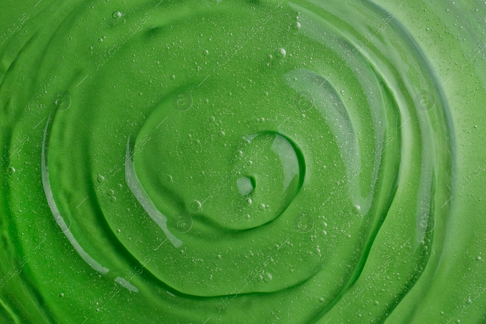 Photo of Texture of green shower gel as background, top view