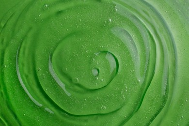 Photo of Texture of green shower gel as background, top view