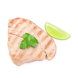 Photo of Delicious tuna steak with parsley and lime isolated on white, top view