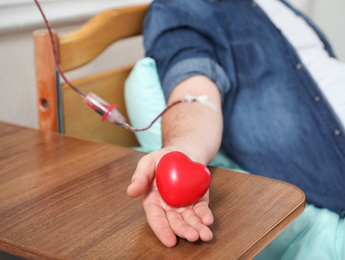 Photo of Man donating blood in hospital, closeup view