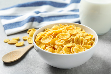 Photo of Tasty corn flakes on light grey table