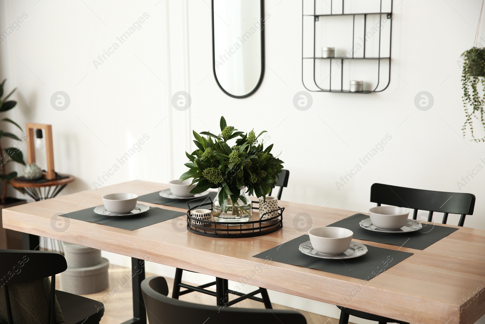 Photo of Stylish wooden dining table and chairs in room. Interior design