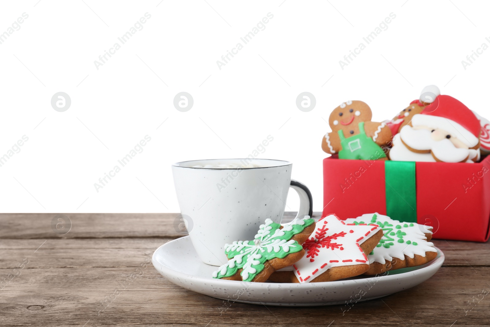 Photo of Tasty Christmas cookies and cup of delicious drink on wooden table against white background
